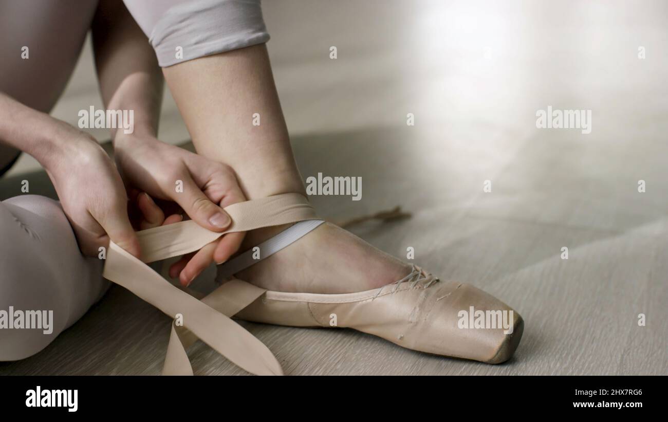 Close Up For Ballet Dancer Putting On Tying Ballet Shoes Ballerina Putting On Her Pointe Shoes