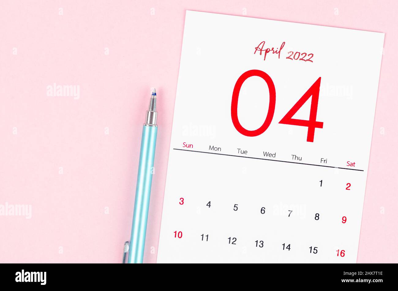 The April 2022 calendar with pen on pink background. Stock Photo
