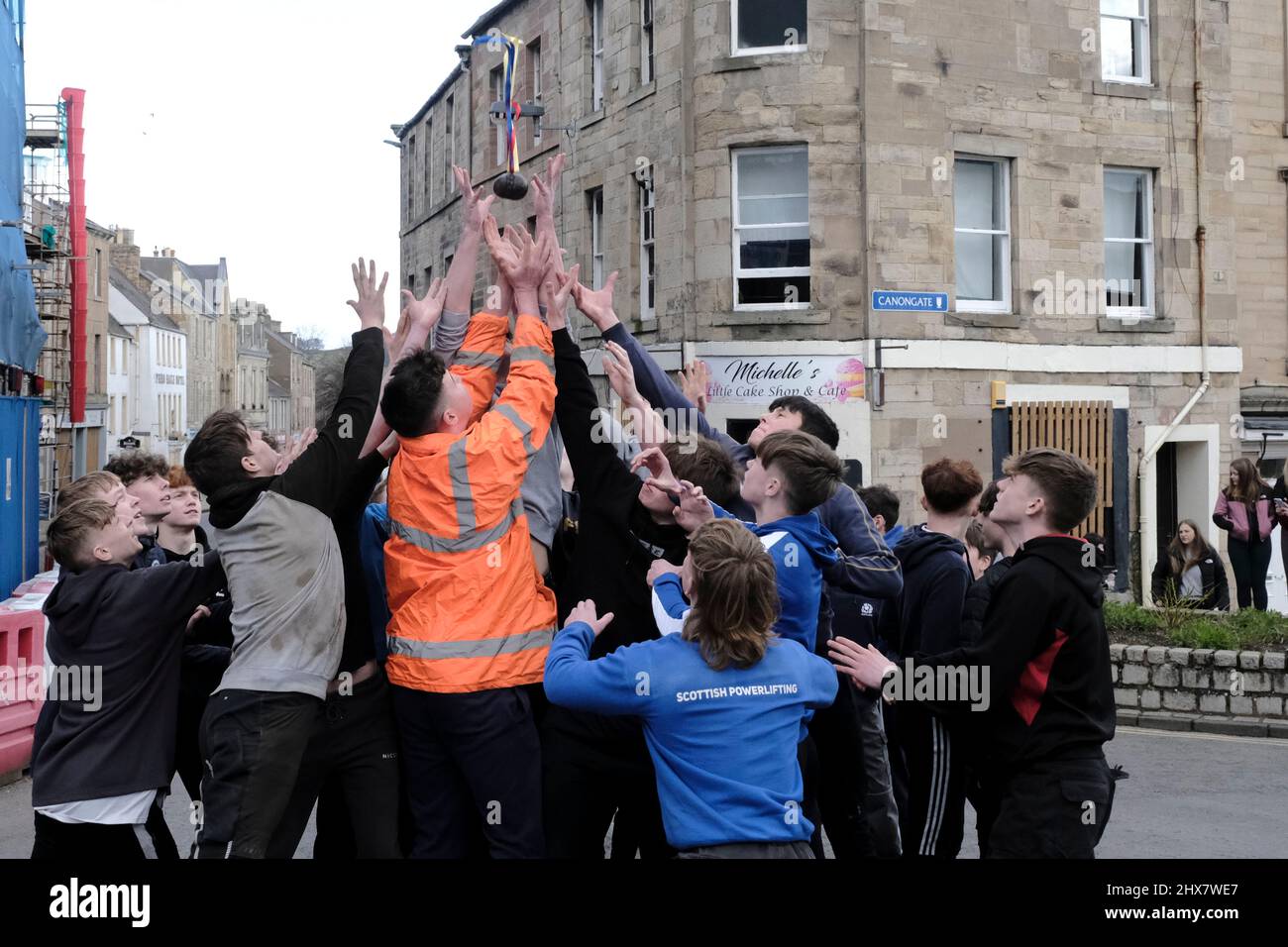 Jedburgh, Thursday 10 March 2022. A group of youths challenge for the 'Schule Ba' the first to be 'hailed' at the start of the annual 'Fastern Eve Handba' event in Jedburgh's High Street in the Scottish Borders on March 10, 2022 in Jedburgh, Scotland. The annual event, which started in the 1700's, takes place today and involves two teams, the Uppies (residents from the higher part of Jedburgh) and the Doonies (residents from the lower part of Jedburgh) getting the ball to either the top or bottom of the town. The ball, which is made of leather, stuffed with straw and decorated with ribbons is Stock Photo