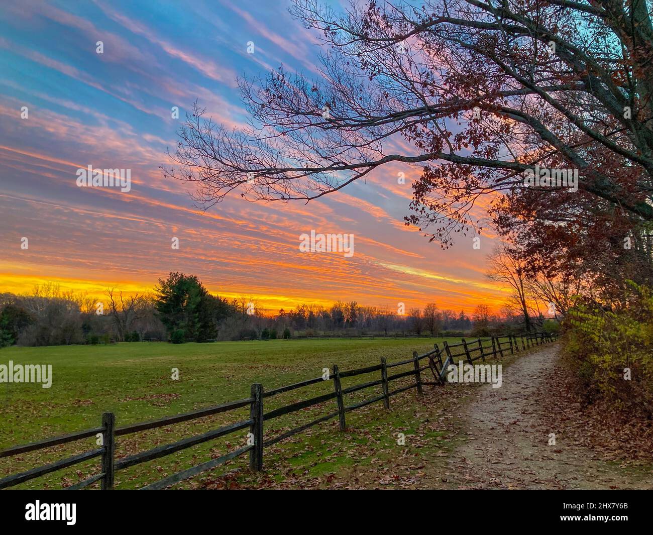 Dramatic sunset with field and fence, Pennsylvania, USA Stock Photo