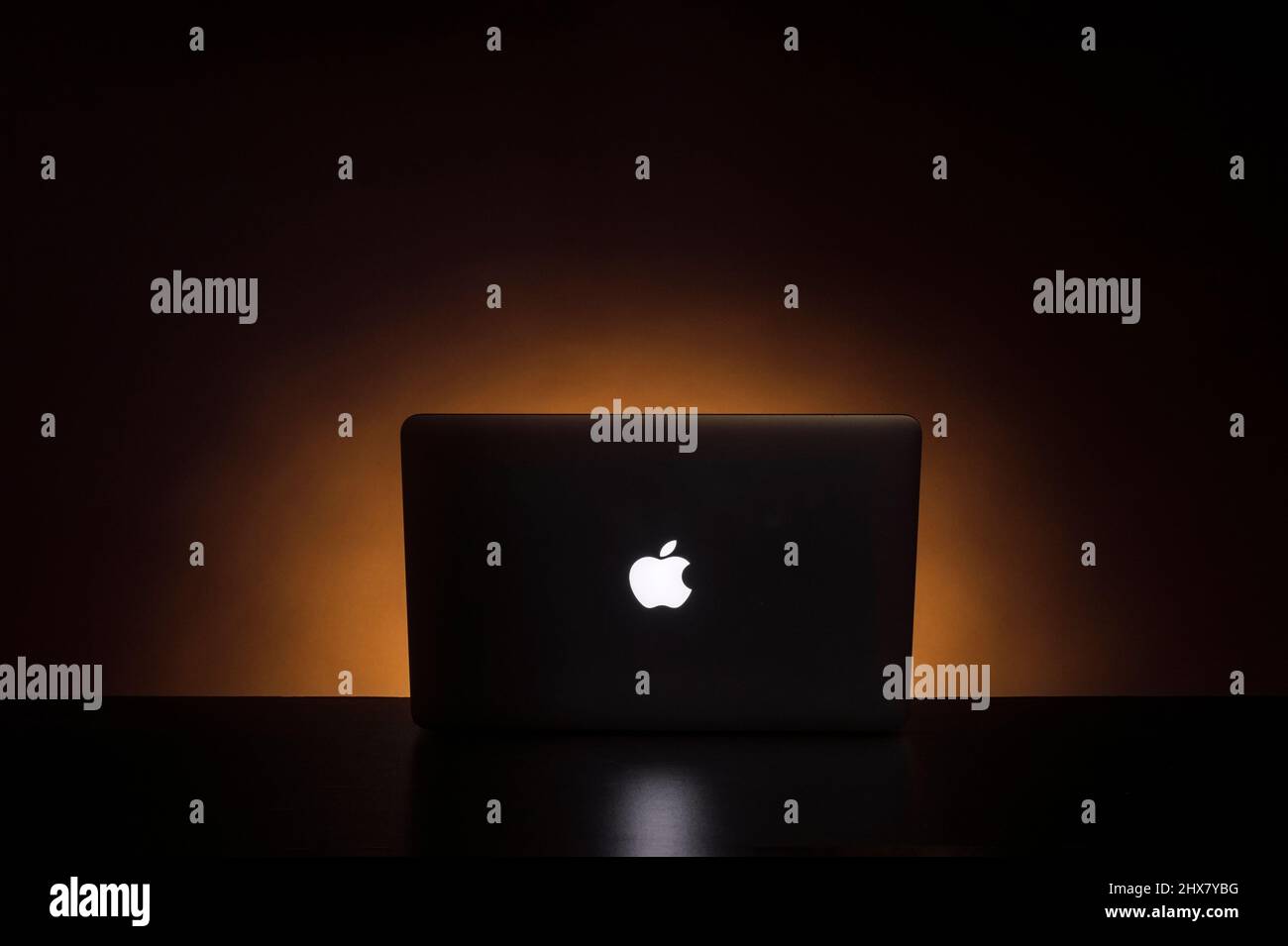 Back of Apple laptop computer with glow Stock Photo