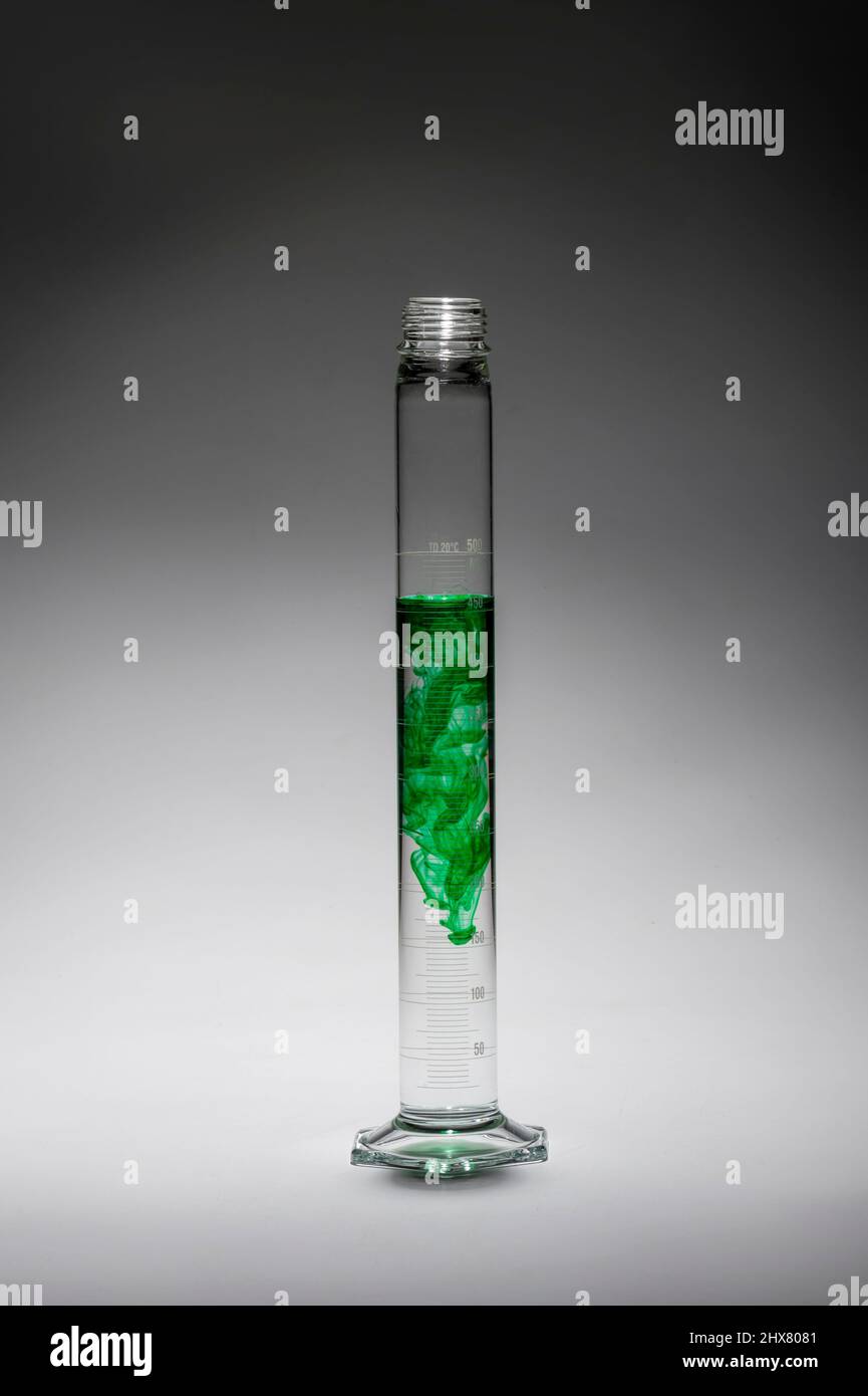 Tall thin beaker with green liquid, USA Stock Photo