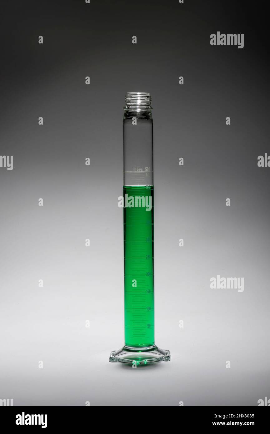 Tall thin beaker with green liquid, USA Stock Photo