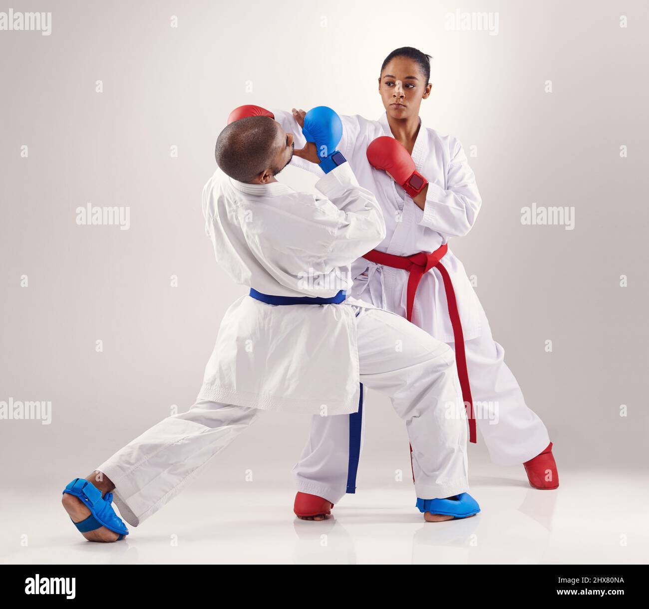 Avoiding her punches. Two people doing karate. Stock Photo