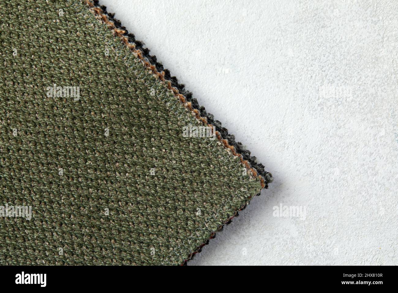 Green linen cloth close-up background. Fabric khaki teak canvas texture. Stock Photo