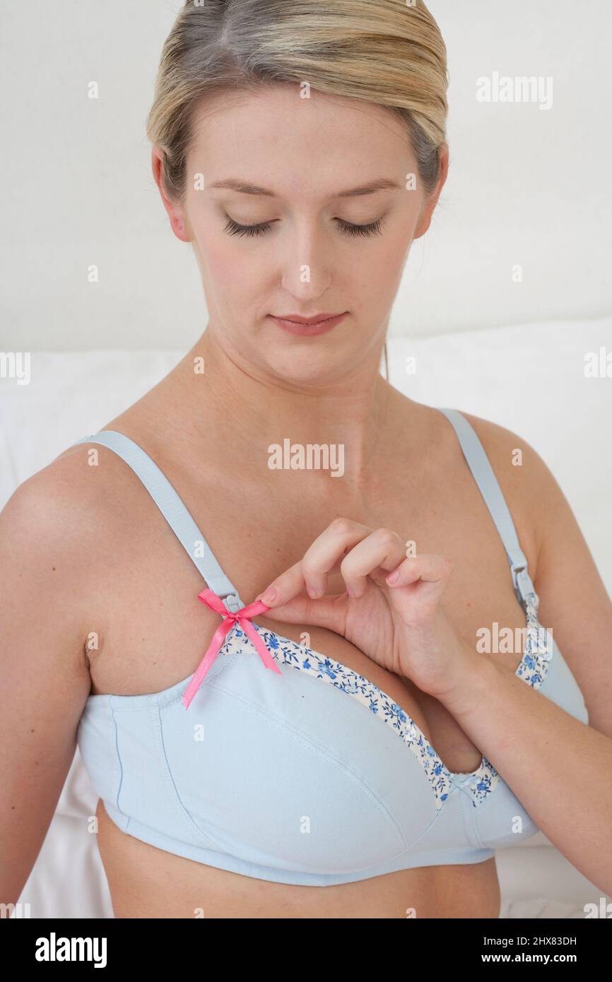 Pregnant woman holding nursing bra with easy breast access for baby feeding  Stock Photo - Alamy
