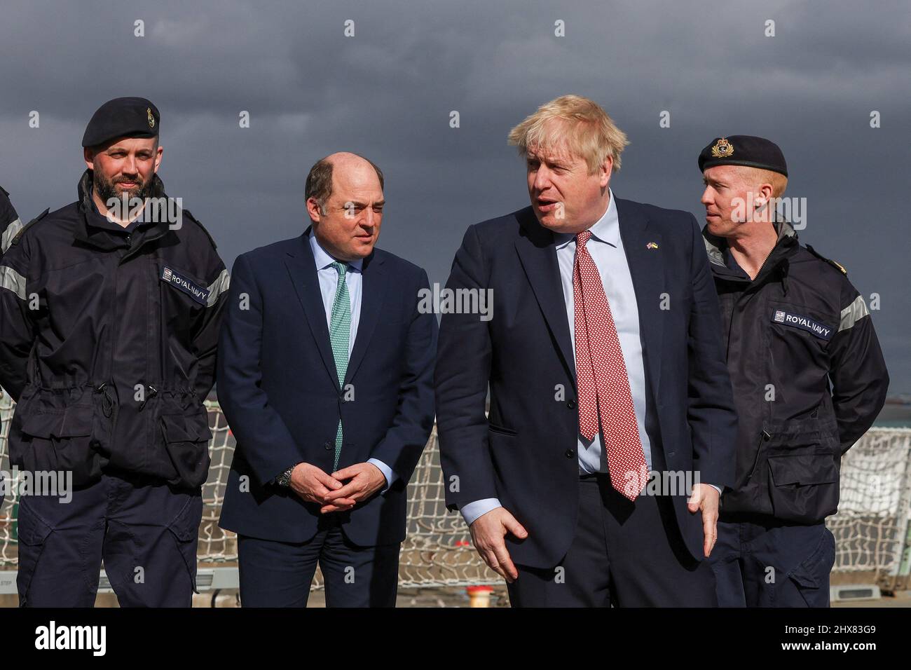 Prime Minister Boris Johnson (second right) and Defence Secretary Ben Wallace (second left) after posing for a picture with members of the ship's company onboard HMS Dauntless, a Type 45 destroyer of the Royal Navy that has undergone a refit, as he visits Cammell Laird shipyard in Merseyside. Picture date: Thursday March 10, 2022. Stock Photo
