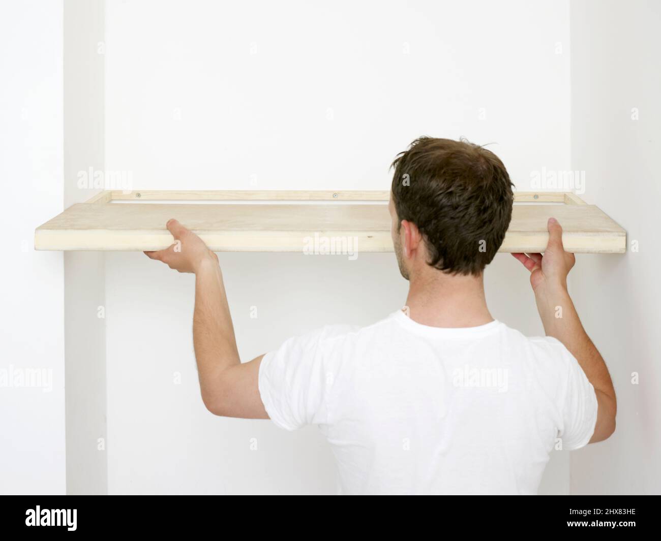 Building and fitting alcove shelves Stock Photo Alamy
