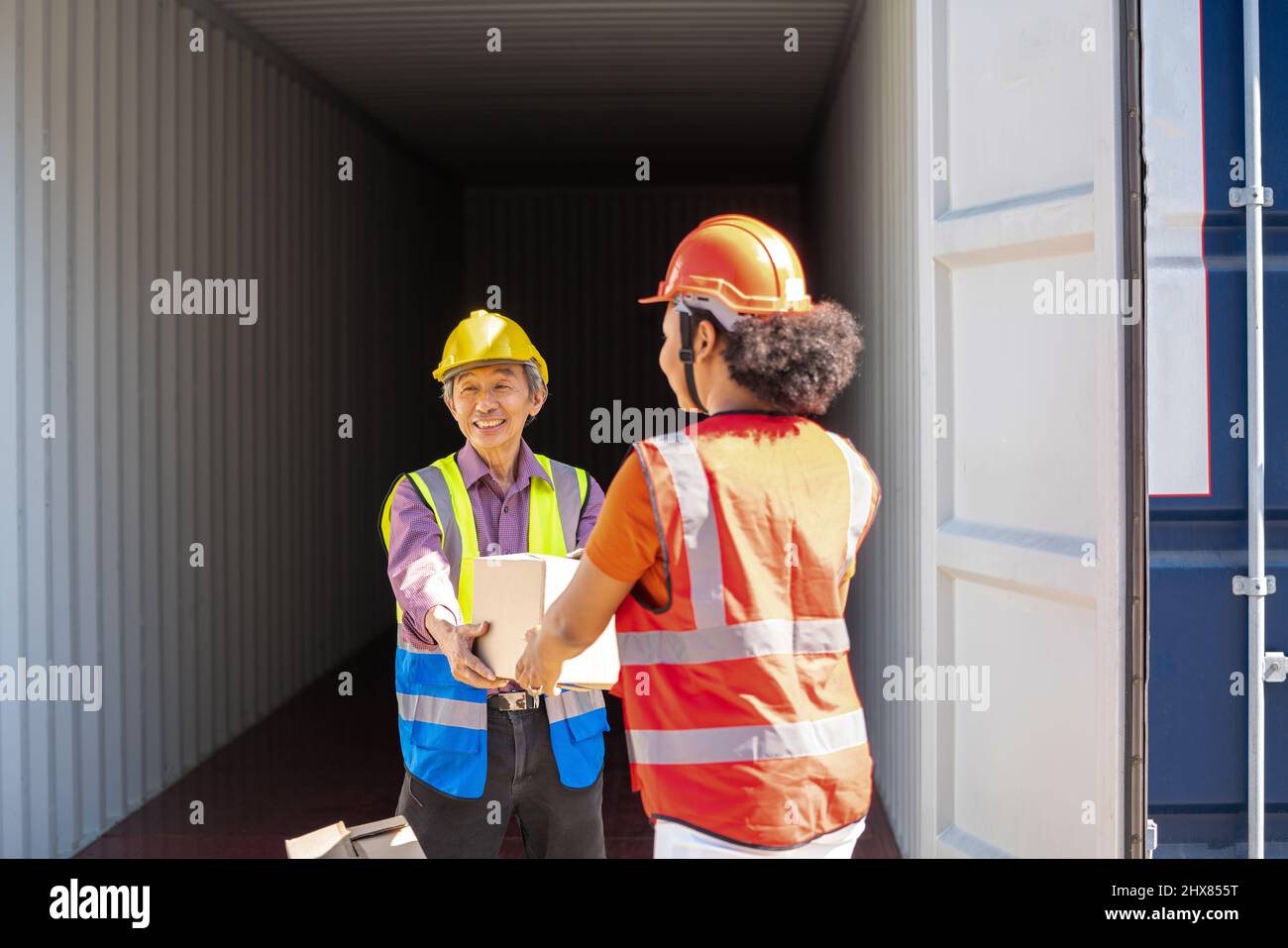 Warehouse cargo business. A Chinese man and a african american woman in