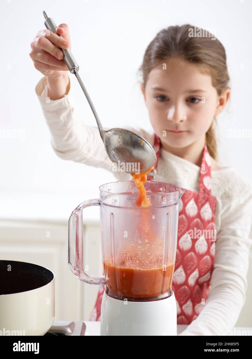 Tomato Soup -ÔøΩFilling a blender with tomato soup and blending (Step 4 of 4) Stock Photo