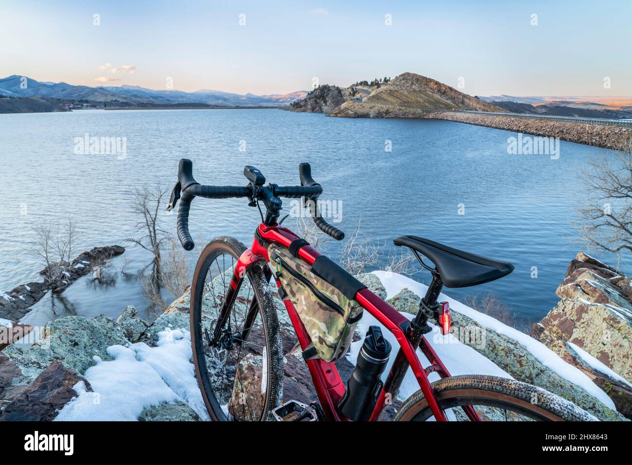 lightweight gravel bike on a rocky cliff overlooking a mountain lake - winter dusk over Horsertooth Reservoir in Fort Collins, Colorado Stock Photo