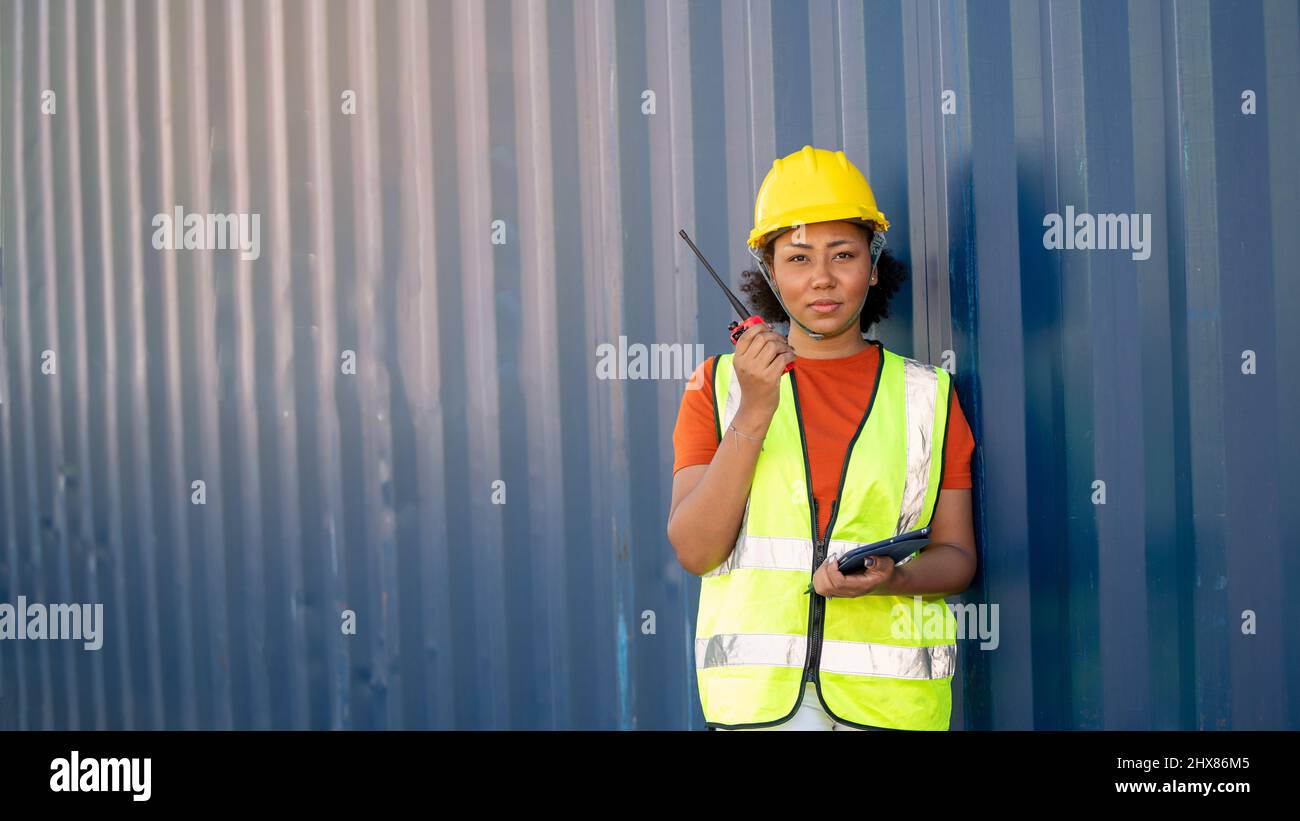 Woman foreman control loading Containers box in warehouse , Worker ...