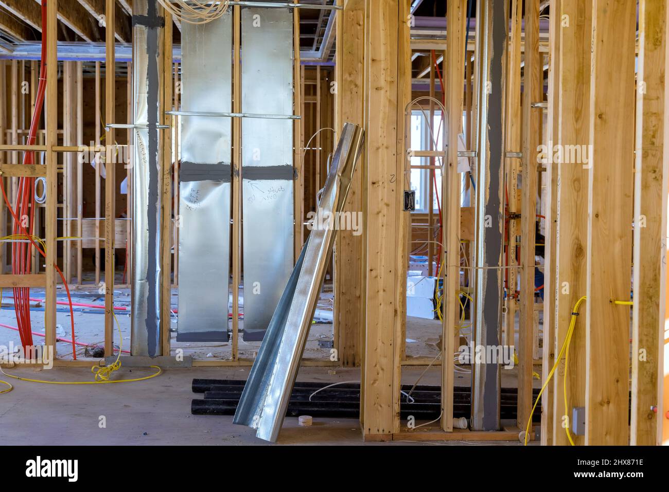Installation of HVAC tubing vents heating system on the wall, amongst