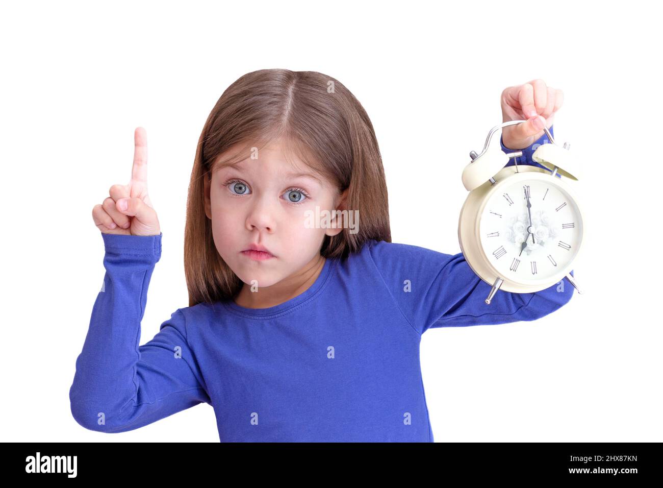 Child holding alarm with 7 o'clock on clock face, concept to wake up
