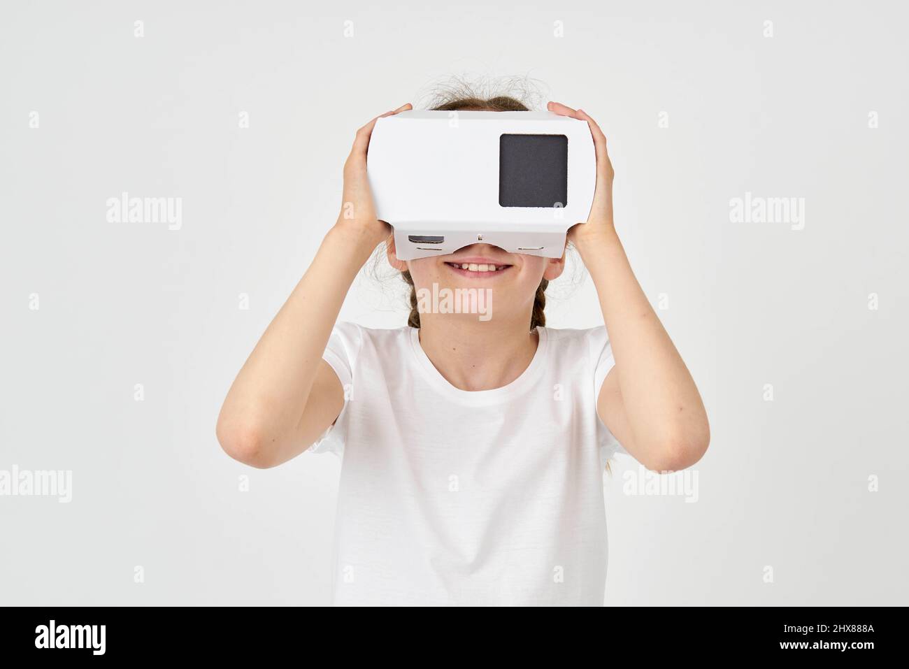 Close up of a girl looking into a virtual reality viewer Stock Photo