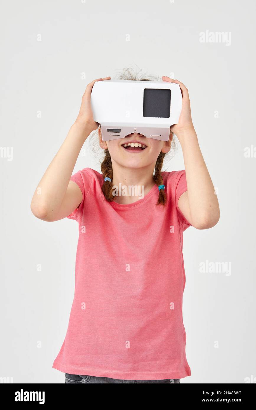 Girl looking into a virtual reality viewer Stock Photo Alamy