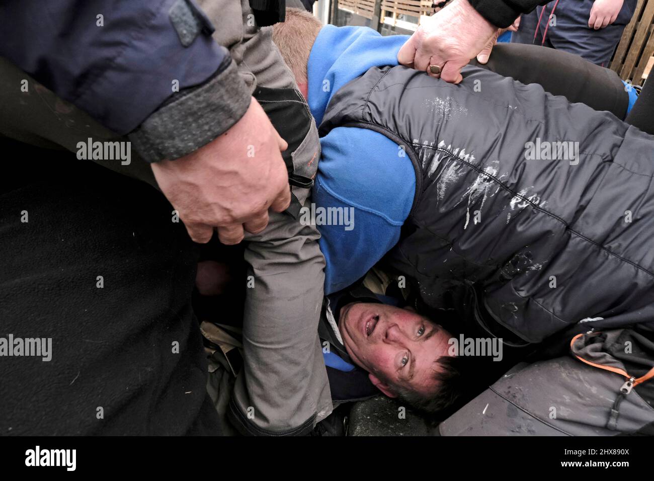 Jedburgh, Thursday 10 March 2022. A man underneath the maul of bodies, appears in a little discomfort, during the Mens Ba at the annual 'Fastern Eve Handba' event in Jedburgh's High Street in the Scottish Borders on March 10, 2022 in Jedburgh, Scotland. The annual event, which started in the 1700's, takes place today and involves two teams, the Uppies (residents from the higher part of Jedburgh) and the Doonies (residents from the lower part of Jedburgh) getting the ball to either the top or bottom of the town. The ball, which is made of leather, stuffed with straw and decorated with ribbons Stock Photo