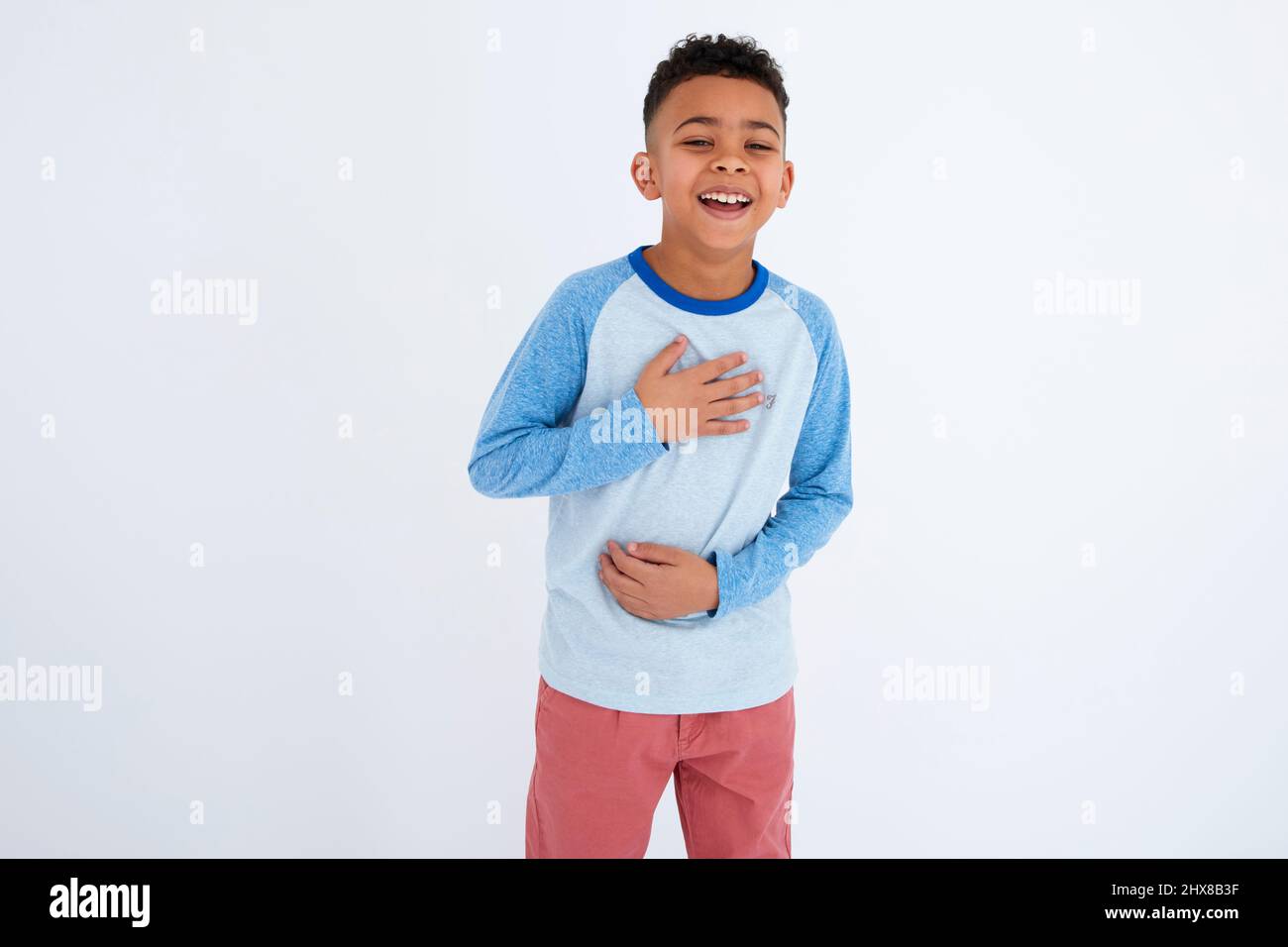 Boy in blue shirt laughing Stock Photo Alamy