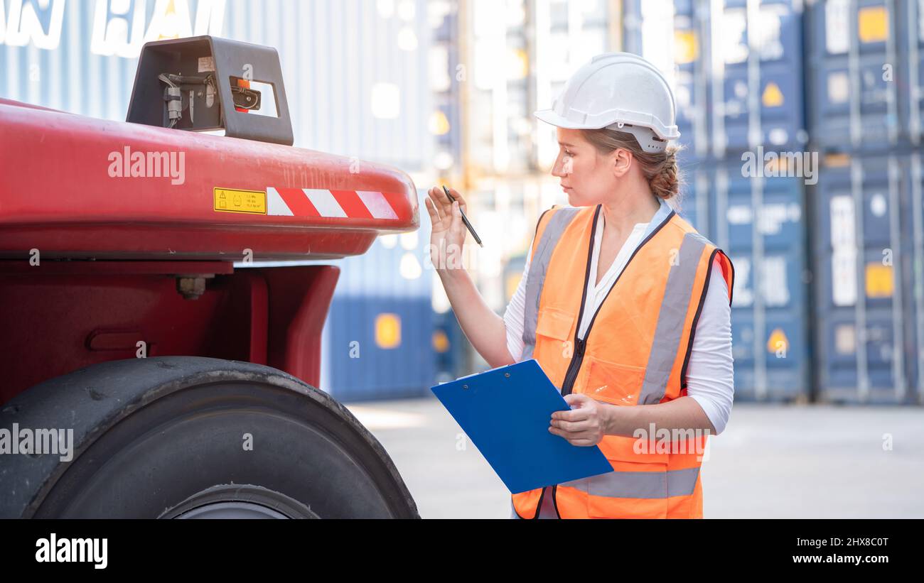 Safety manager checking wheel of cargo container forklift, Foreman pre check truck tires concept industry safety and service Stock Photo