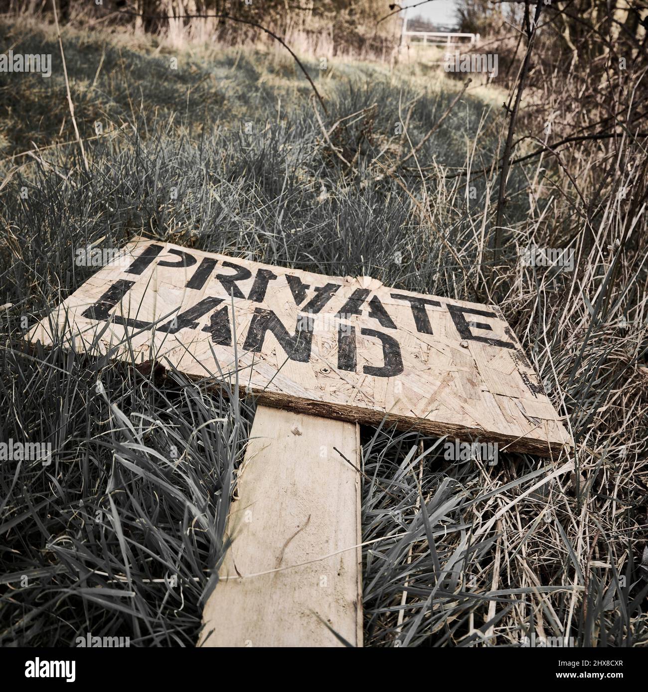 Private land sign laying flat on the ground Stock Photo