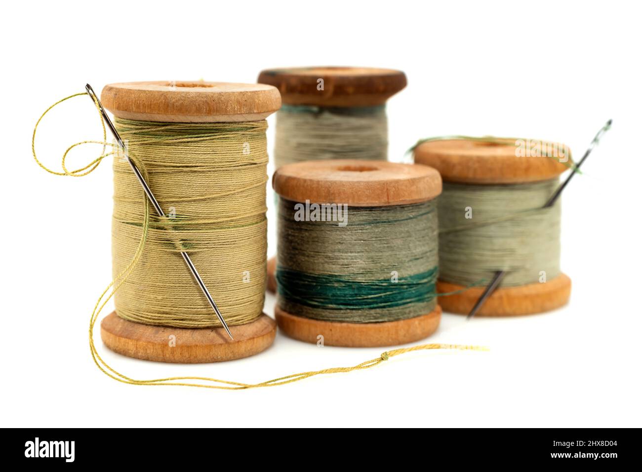 Spools of colored threads for sewing on a white background. Threads with needles isolate Stock Photo