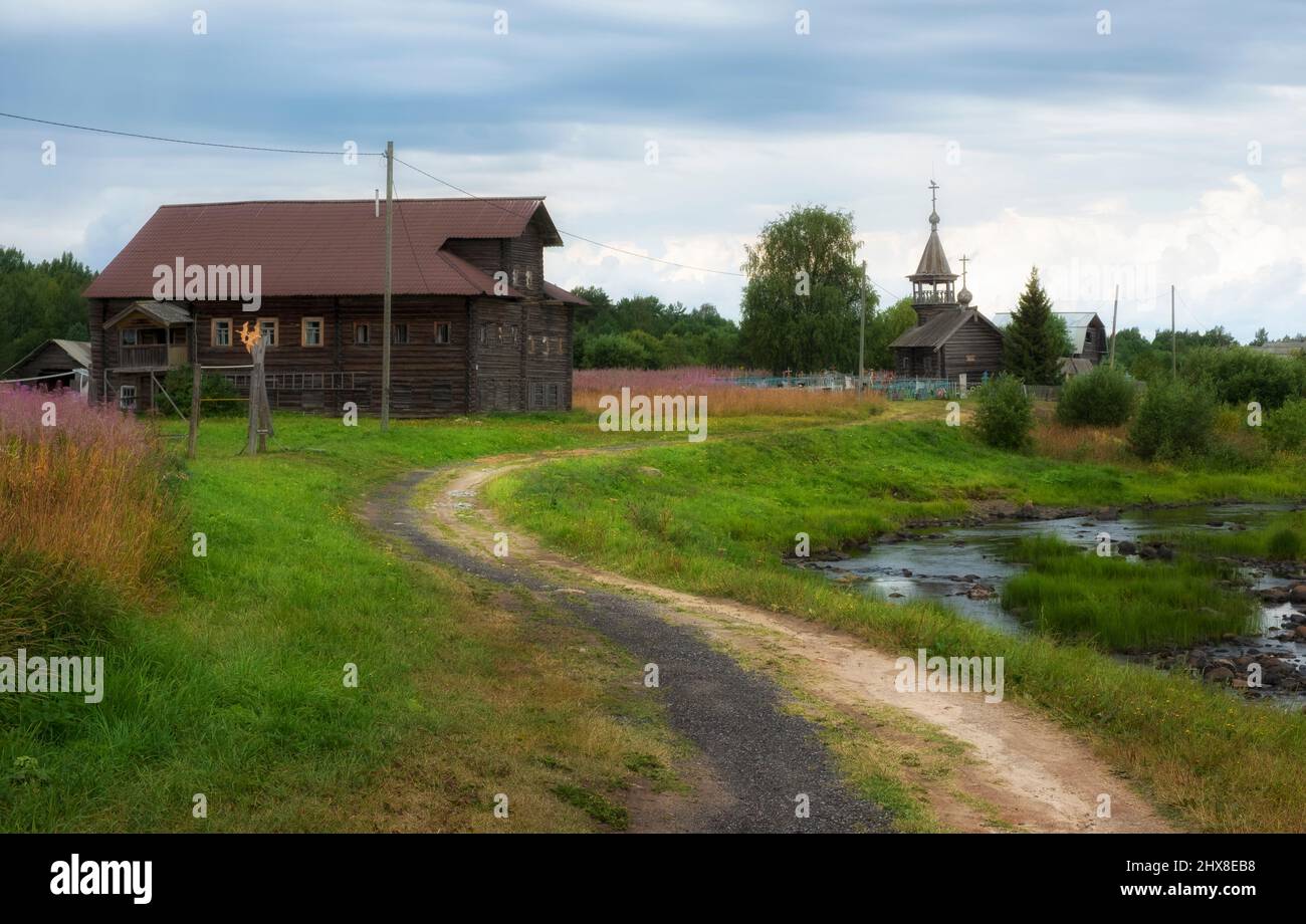 The historic village of Pyalma in the Republic of Karelia on the river bank during summer rain Stock Photo