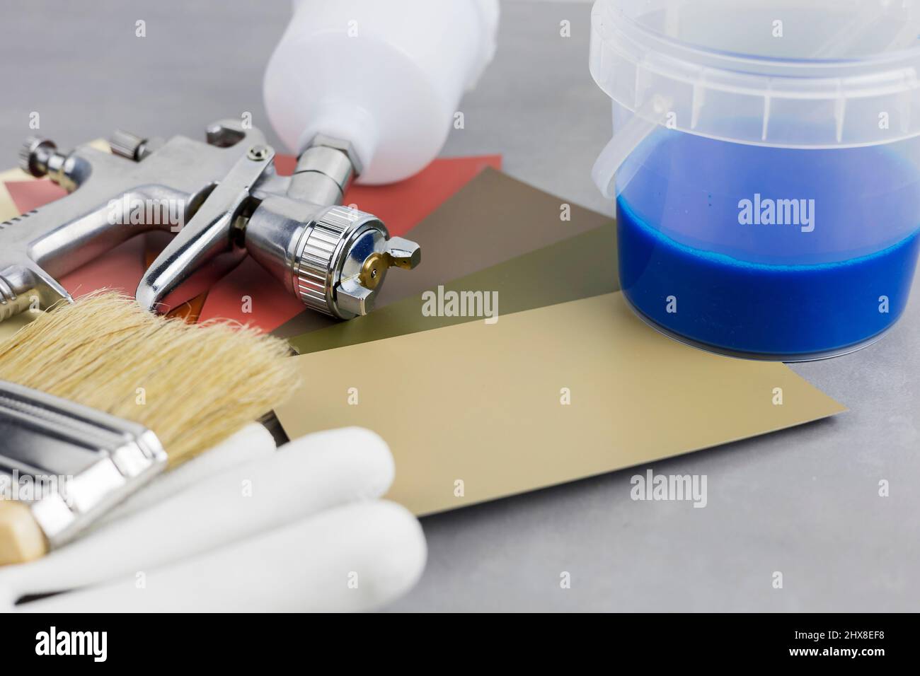 Paint spray gun at work at the workplace in the Paint Brush