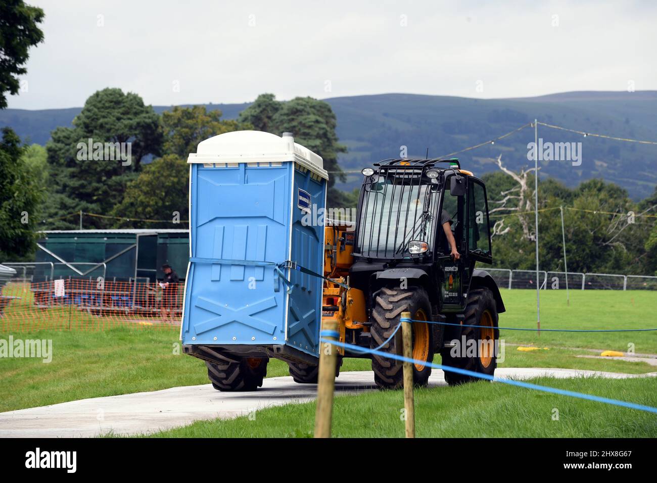 Workers onsite at the Glanusk Estate in Crickhowell, preparing the site in readiness for the 2021 Green Man Festival.   Toilets arriving on site  .  P Stock Photo