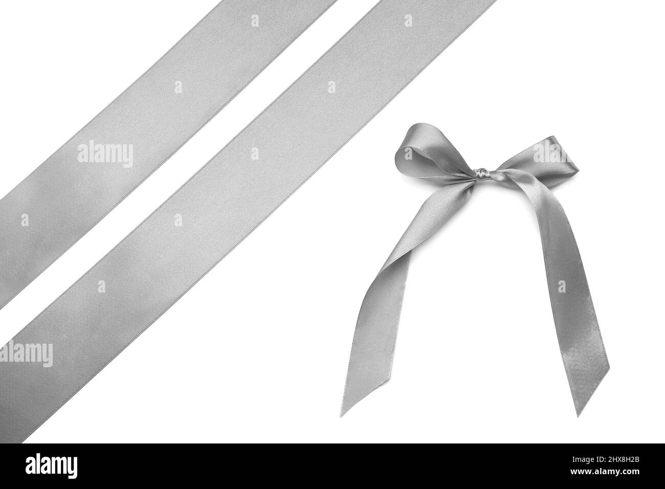 Beautiful silver bow with ribbons on white background Stock Photo - Alamy