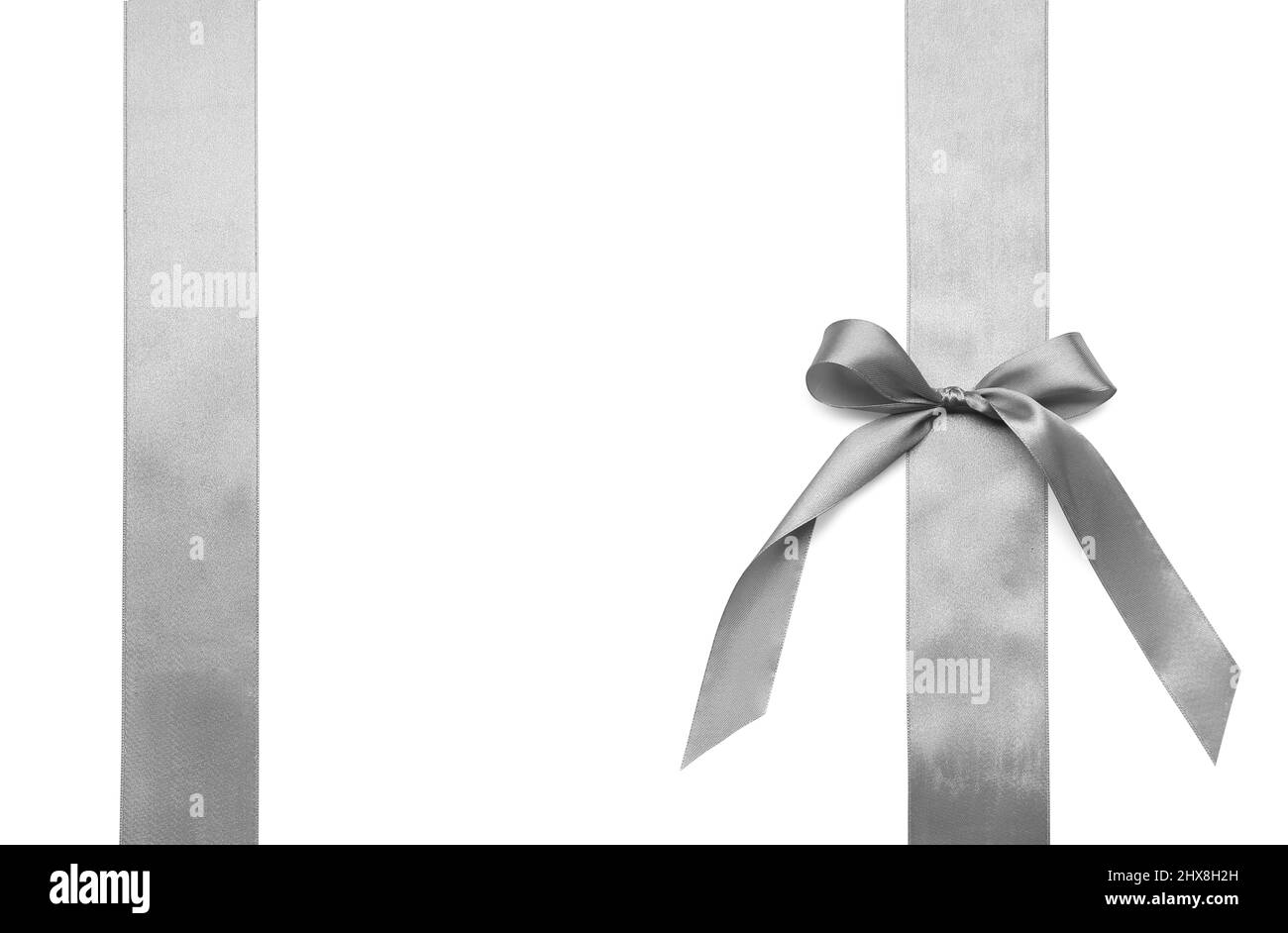 Beautiful silver bow with ribbons on white background Stock Photo - Alamy