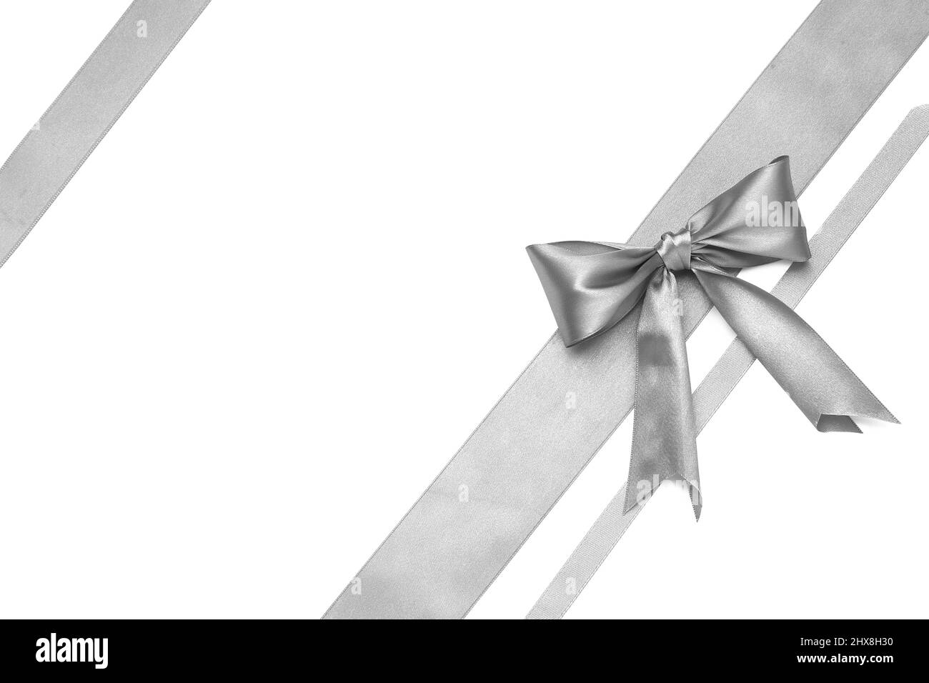 Beautiful silver bow with ribbons on white background Stock Photo - Alamy