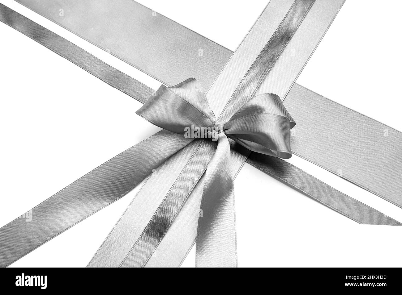 Beautiful silver bow with ribbons on white background Stock Photo - Alamy