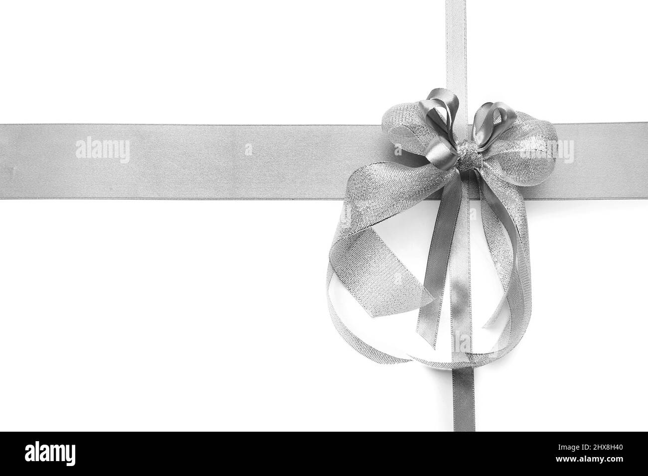 Beautiful silver bow with ribbons on white background Stock Photo - Alamy