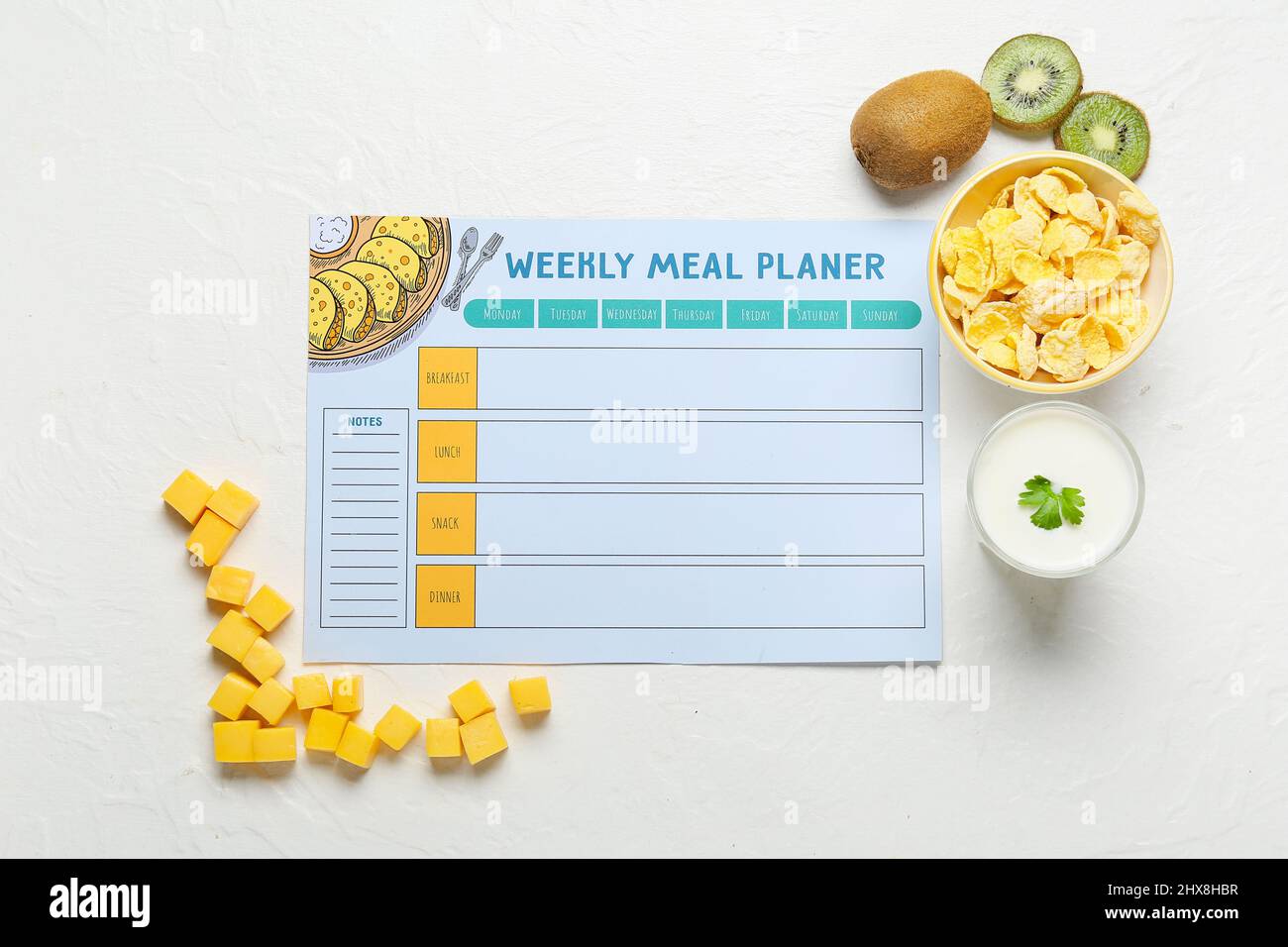 Weekly meal planner and different healthy products on light background Stock Photo