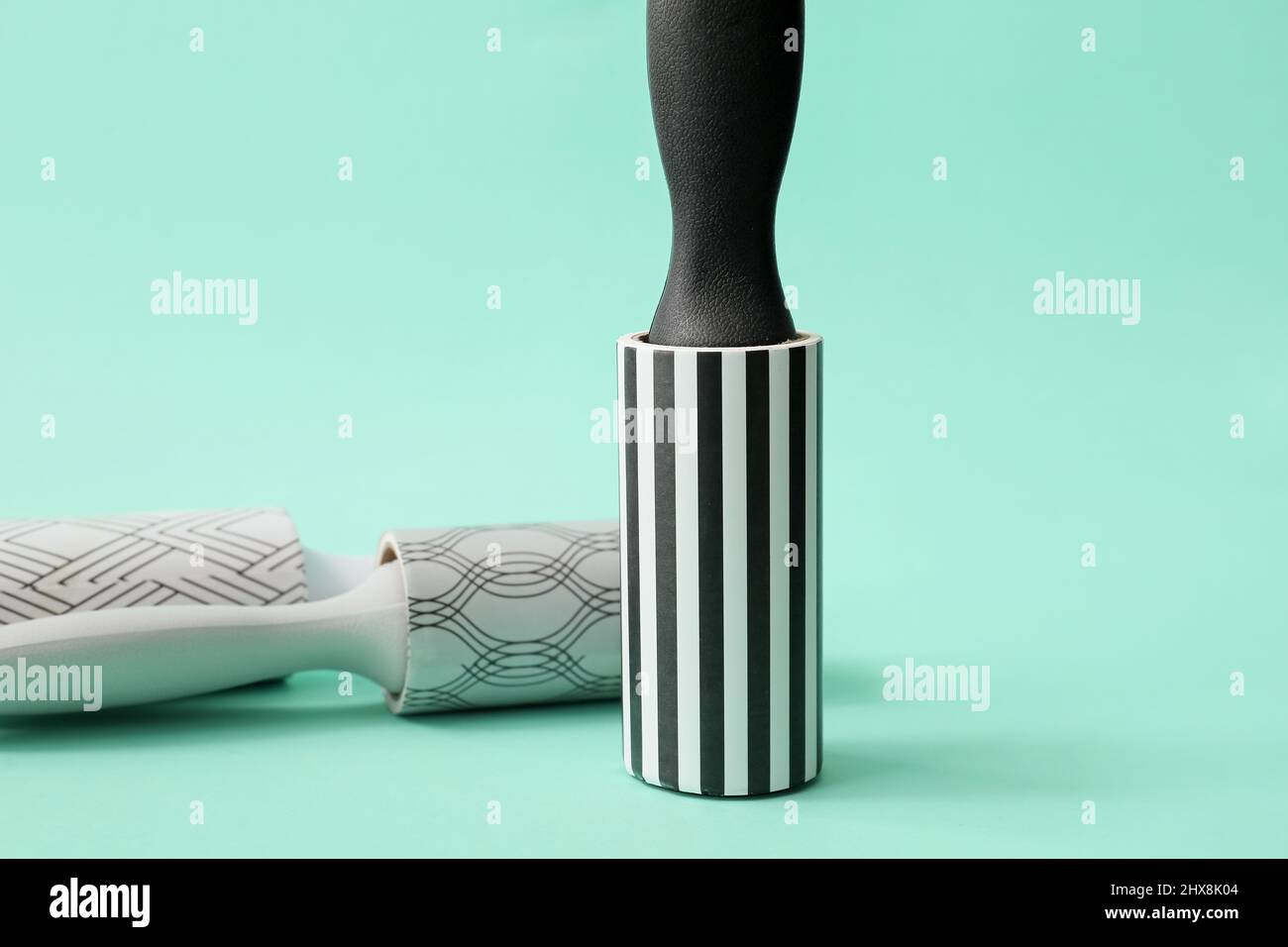 New lint rollers on color background Stock Photo