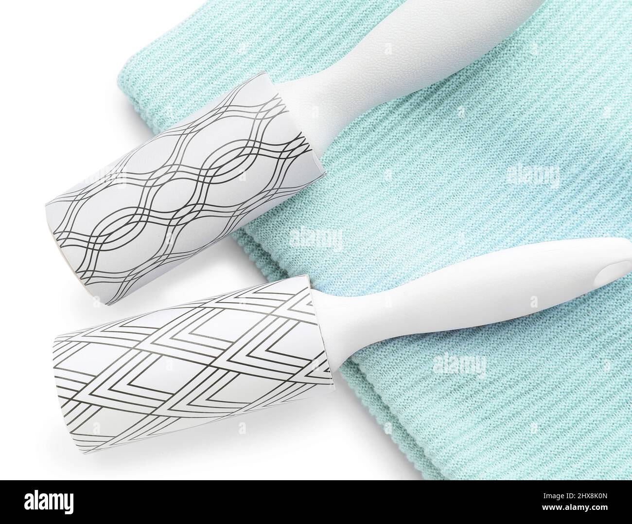 New lint rollers with clothes on white background Stock Photo