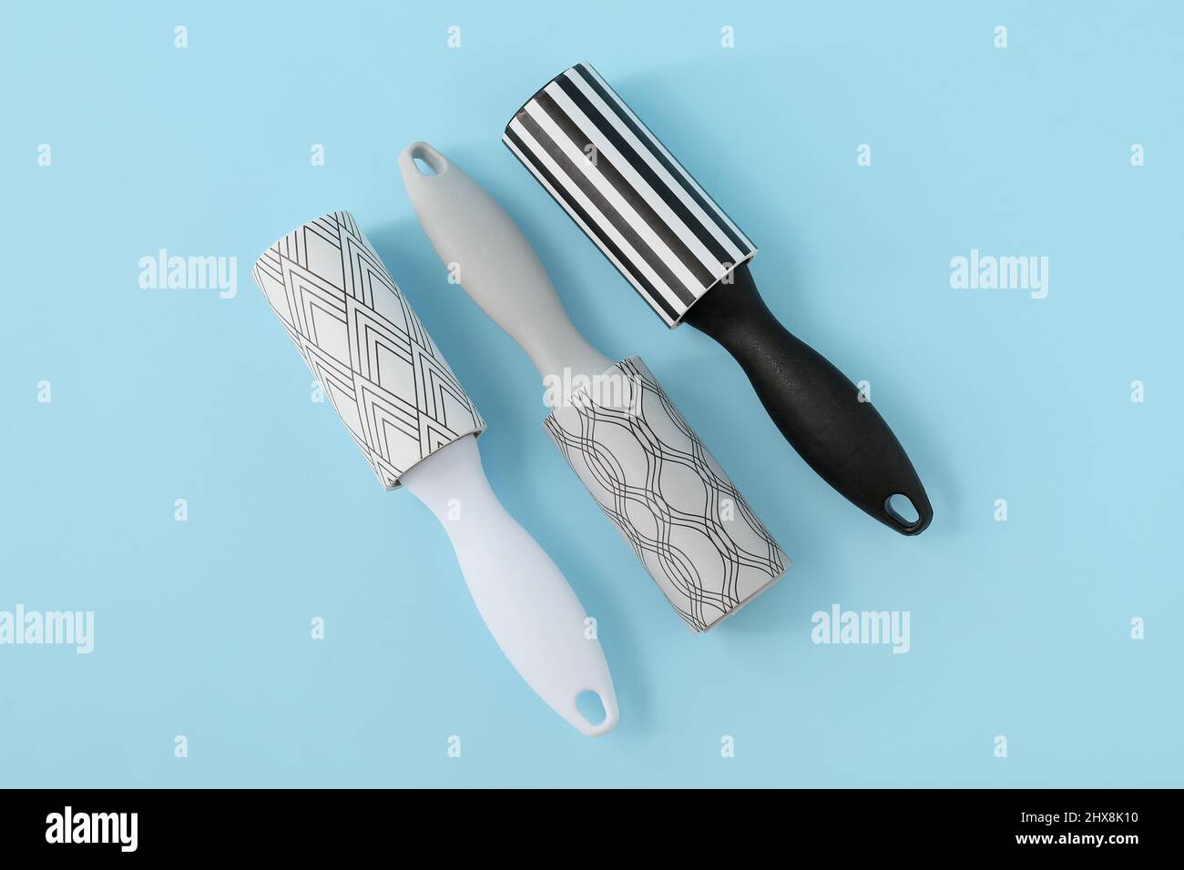 New lint rollers on blue background Stock Photo