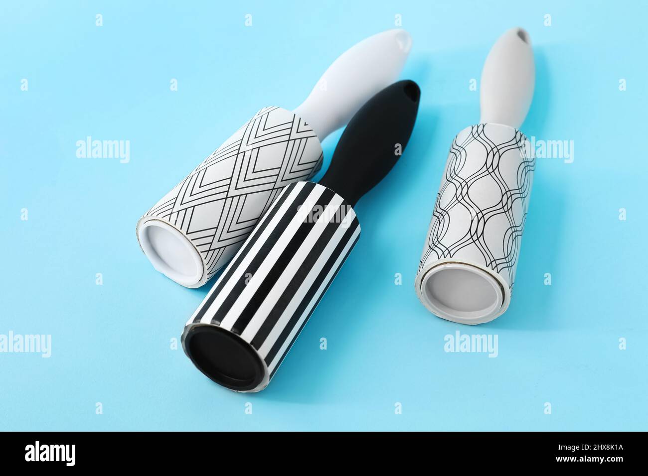 New lint rollers on blue background Stock Photo