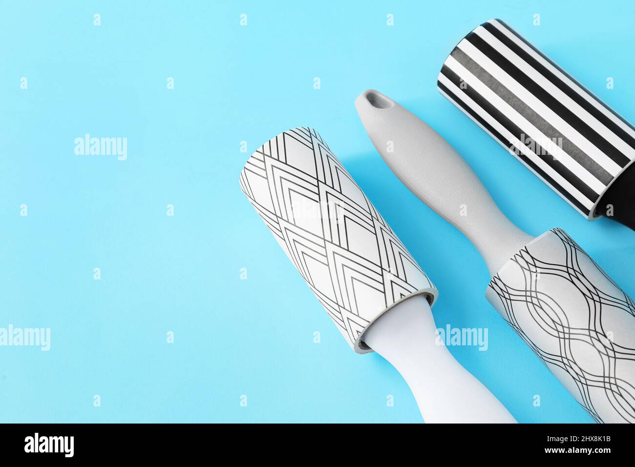 New lint rollers on blue background Stock Photo
