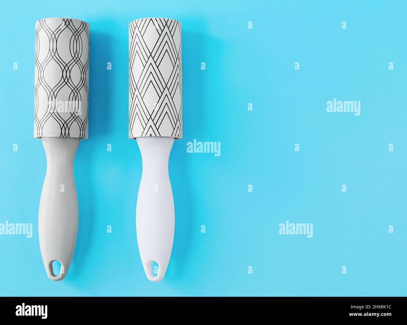 New lint rollers on blue background Stock Photo