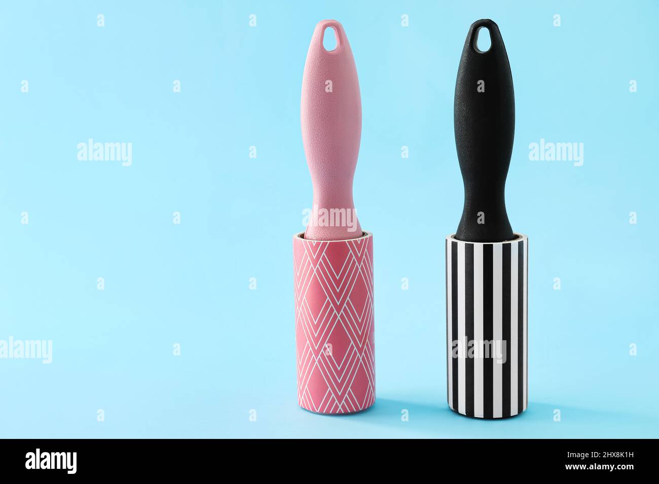 New lint rollers on blue background Stock Photo