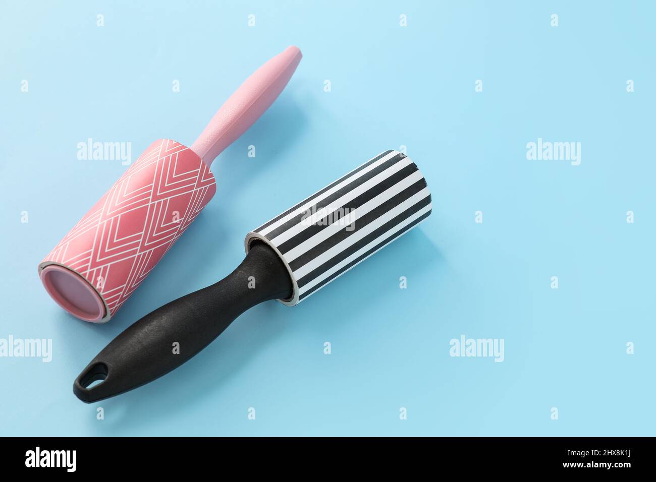 New lint rollers on blue background Stock Photo