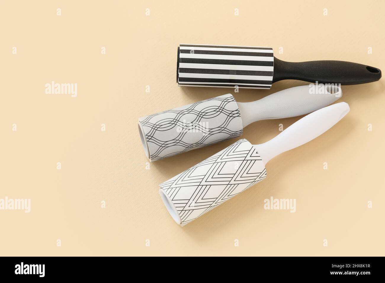 New lint rollers on beige background Stock Photo