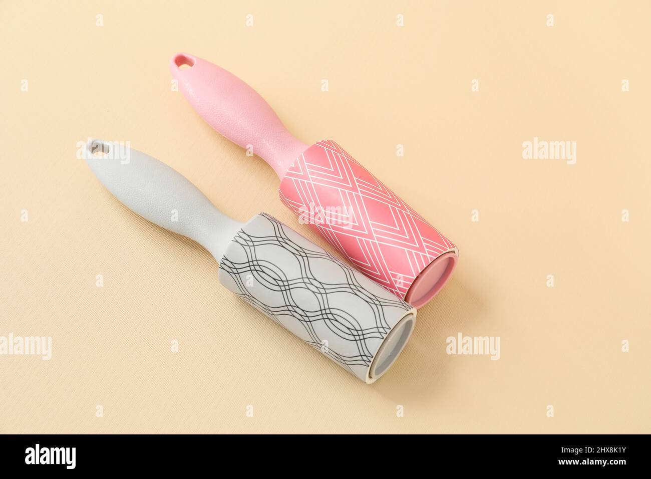 New lint rollers on beige background Stock Photo