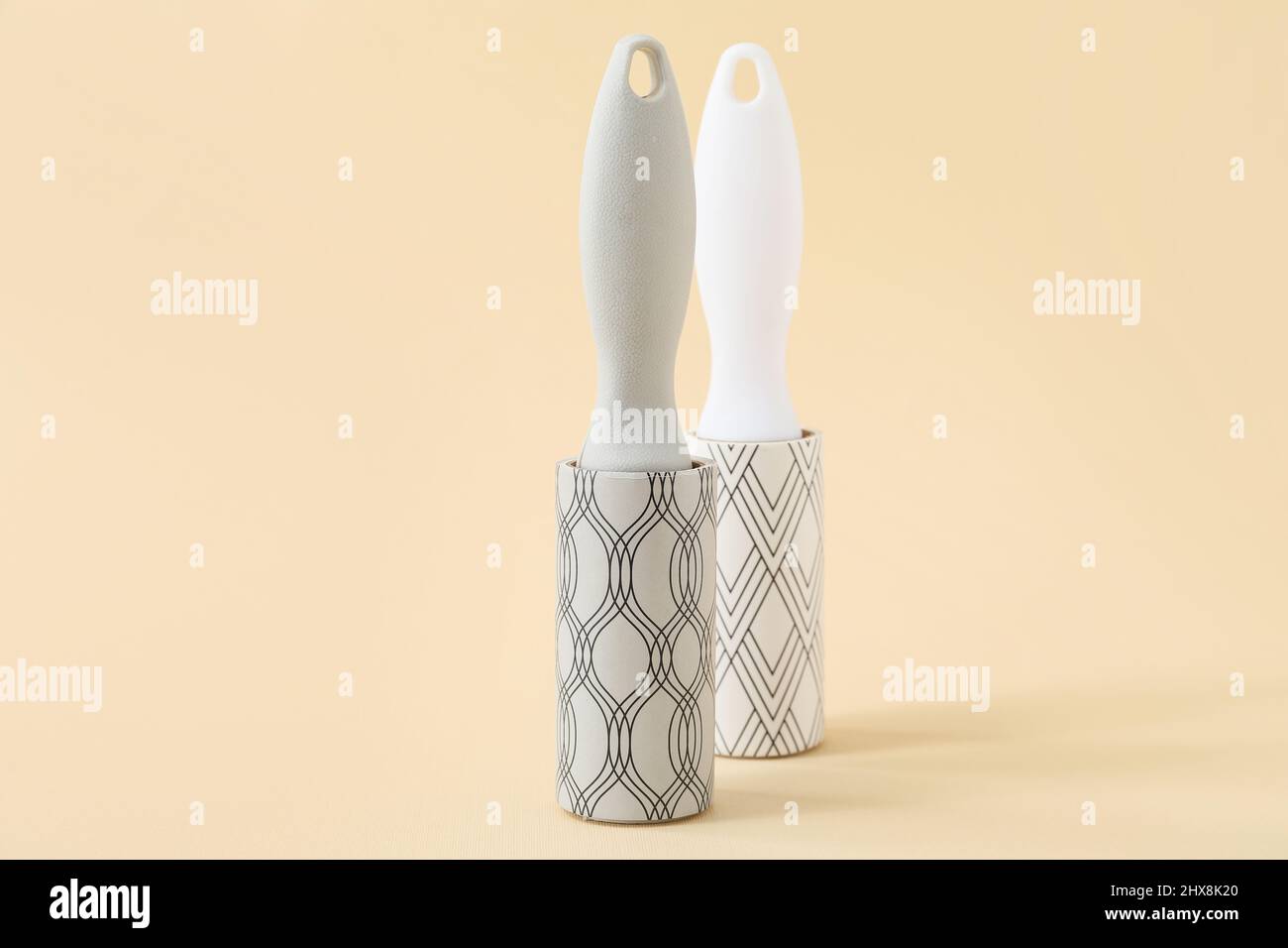 New lint rollers on beige background Stock Photo