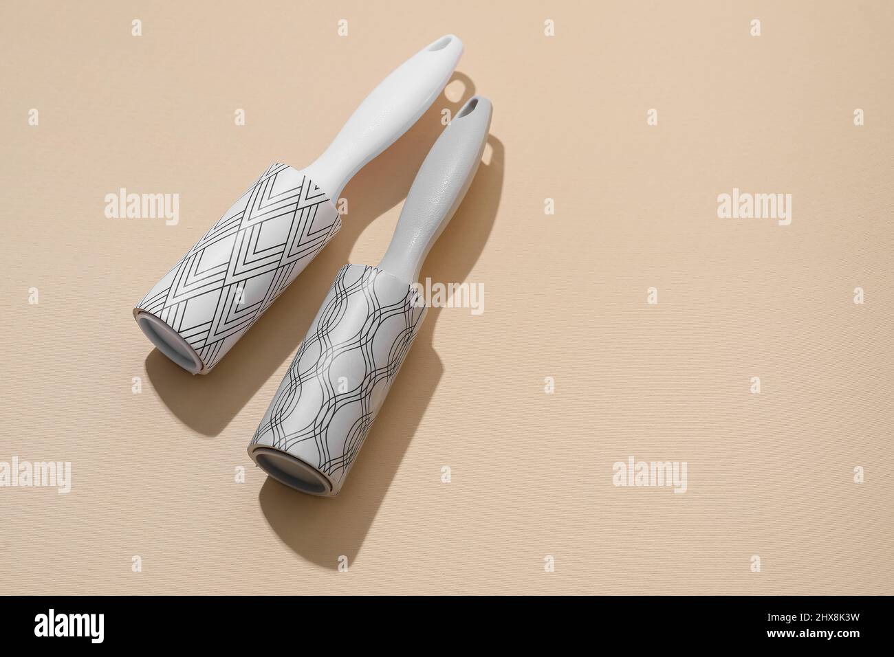 New lint rollers on beige background Stock Photo