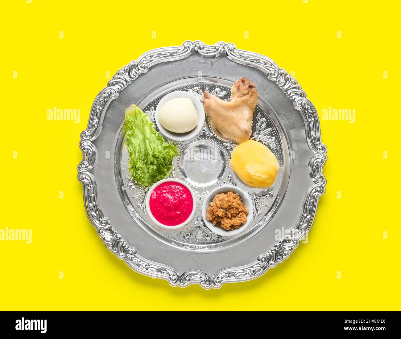 Passover Seder plate with traditional food on color background, top ...