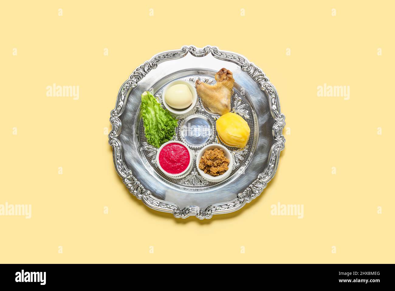 Passover Seder plate with traditional food on light background, top ...