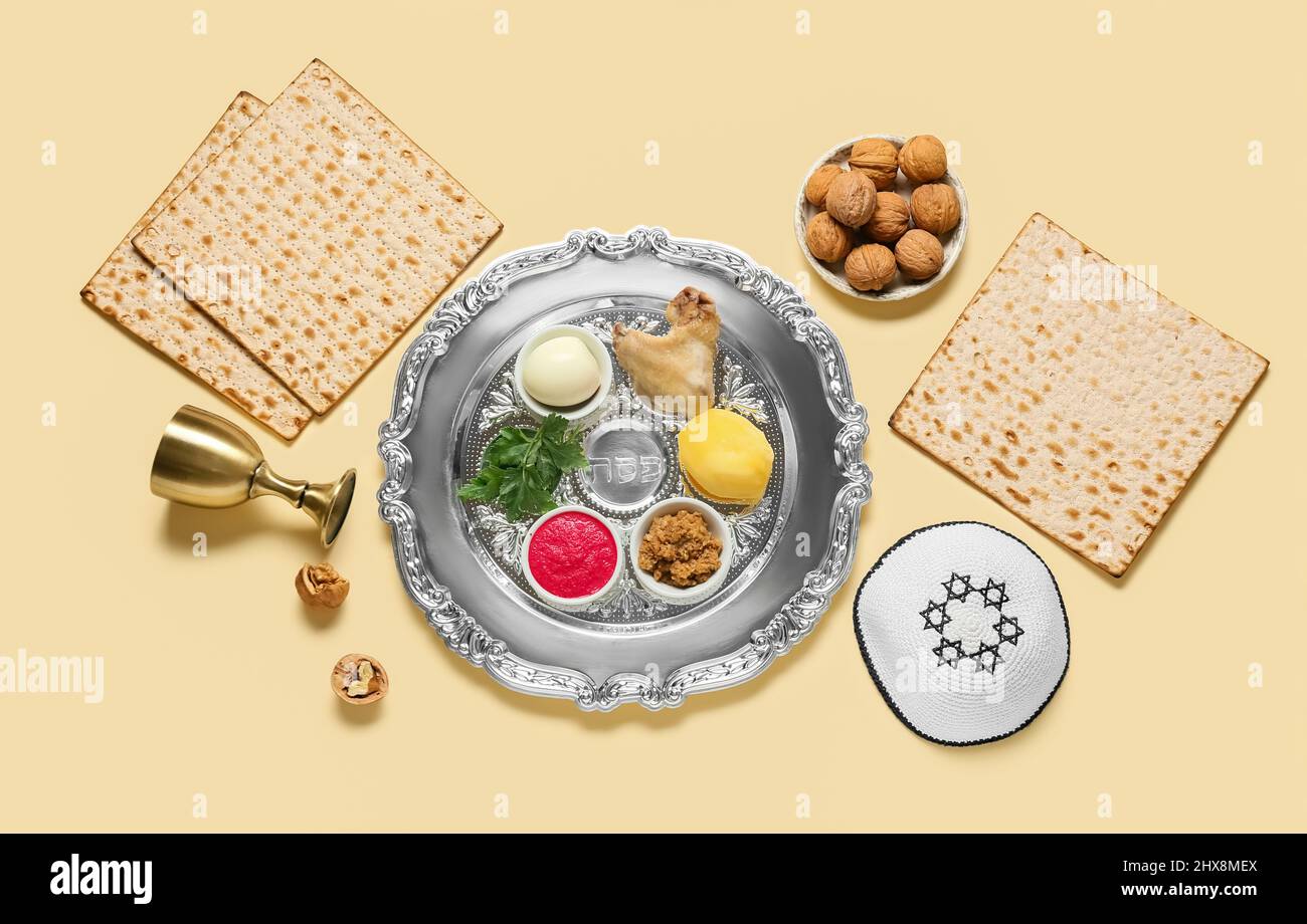Passover Seder plate with traditional food and kippah on light ...