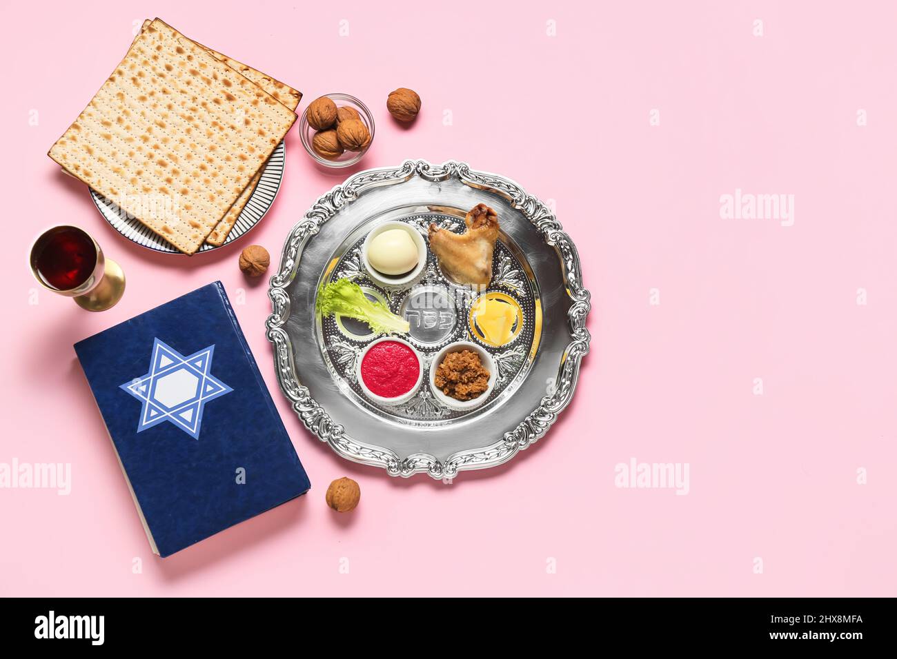 Passover Seder plate with traditional food and Torah on color